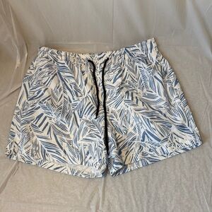 Men’s Large swim trunks feature a blue and white tropical leaf or palm print.